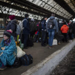 AP PHOTOS: Exit out of Ukraine: escape by foot, train, car