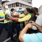 Protester drives at New Zealand police as cordon tightens