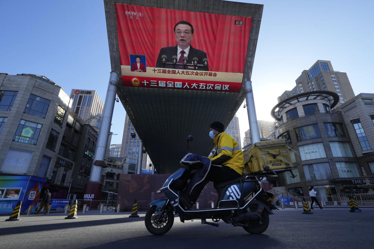 China cuts economic growth goal as it tries to reverse slump