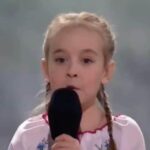 Viral ‘Let It Go’ Girl Sings Ukrainian National Anthem at Charity Concert in Poland (Video)