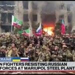 Chechen unit fighting with Russia stands before a burning building and claims it has “cleansed and destroyed” Mariupol.