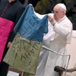 Pope Francis condemns ‘massacre of Bucha’ and kisses Ukrainian flag