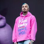 Chris Brown defends taking risqué photos with female fans at meet-and-greets and says he’s not like other ‘lame’ artists ‘that won’t make eye contact’ with fans