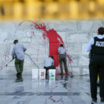 Workers Clean Up Washington Monument After Vandalism