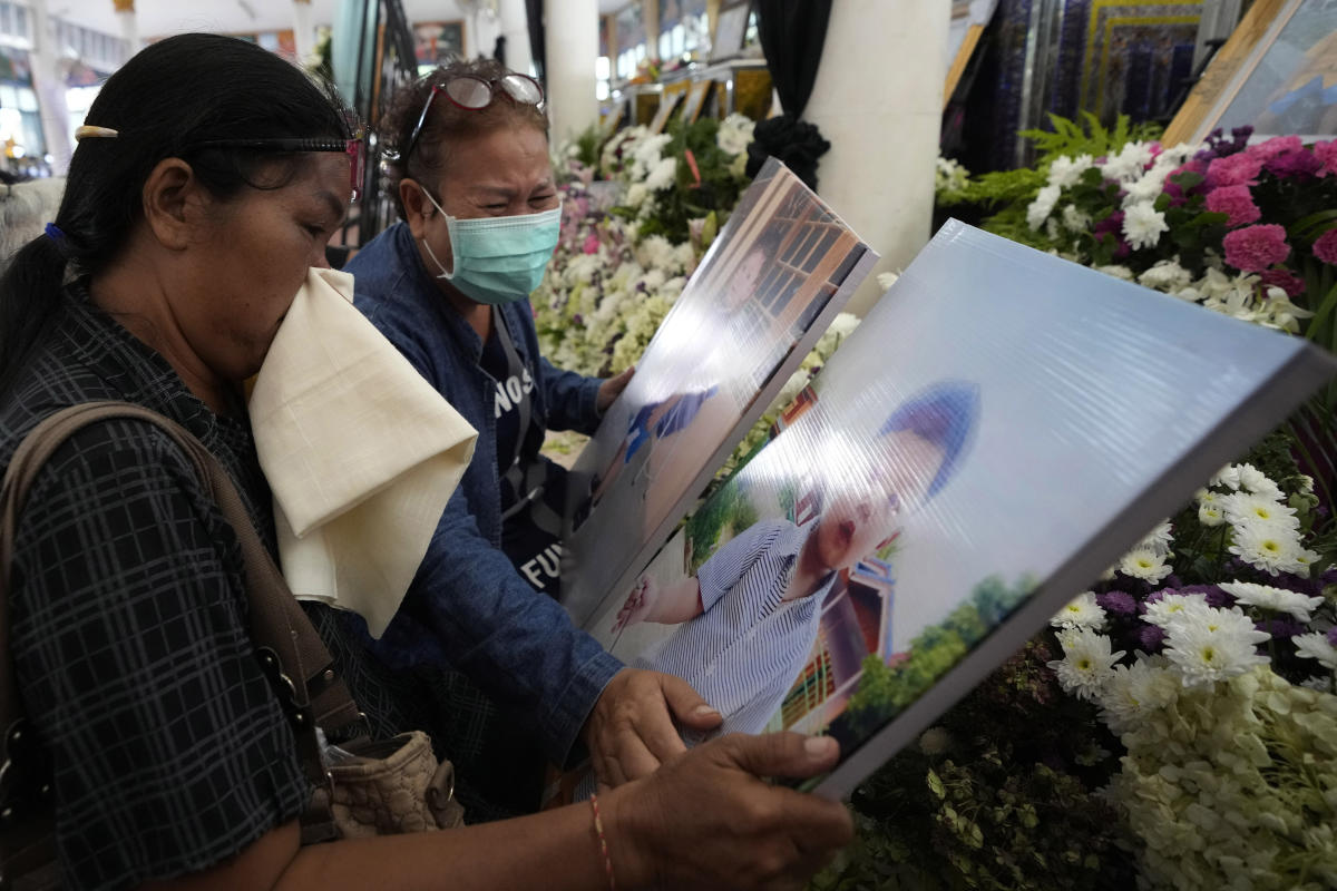 Grieving families pray at Thai temple for slain victims