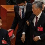 Live broadcast shows former Chinese president being abruptly escorted out of the Communist Party Congress closing ceremony