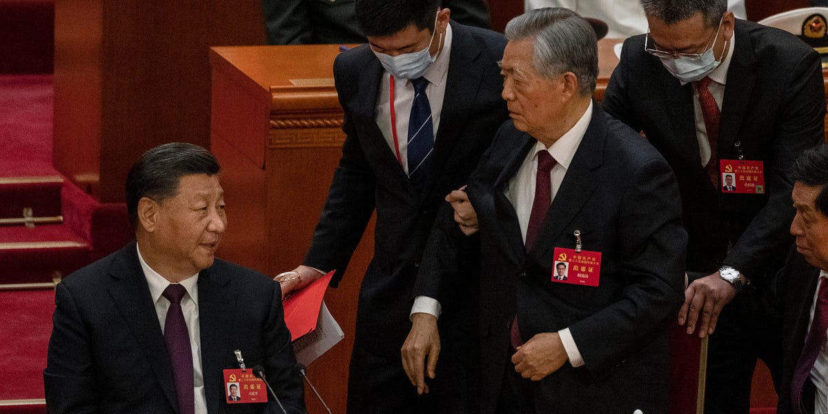 Live broadcast shows former Chinese president being abruptly escorted out of the Communist Party Congress closing ceremony