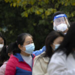 China reports 10,000 new virus cases, capital closes parks