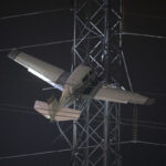 Crews work to rescue 2 in plane caught high in power lines